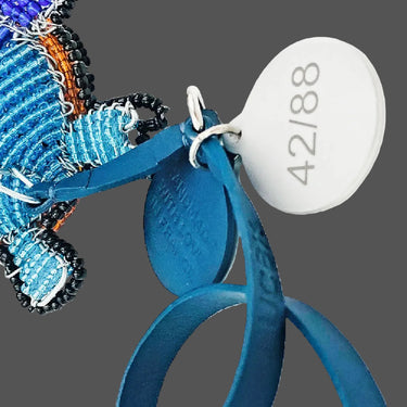 Decorative keychain with blue and orange beads on a white background