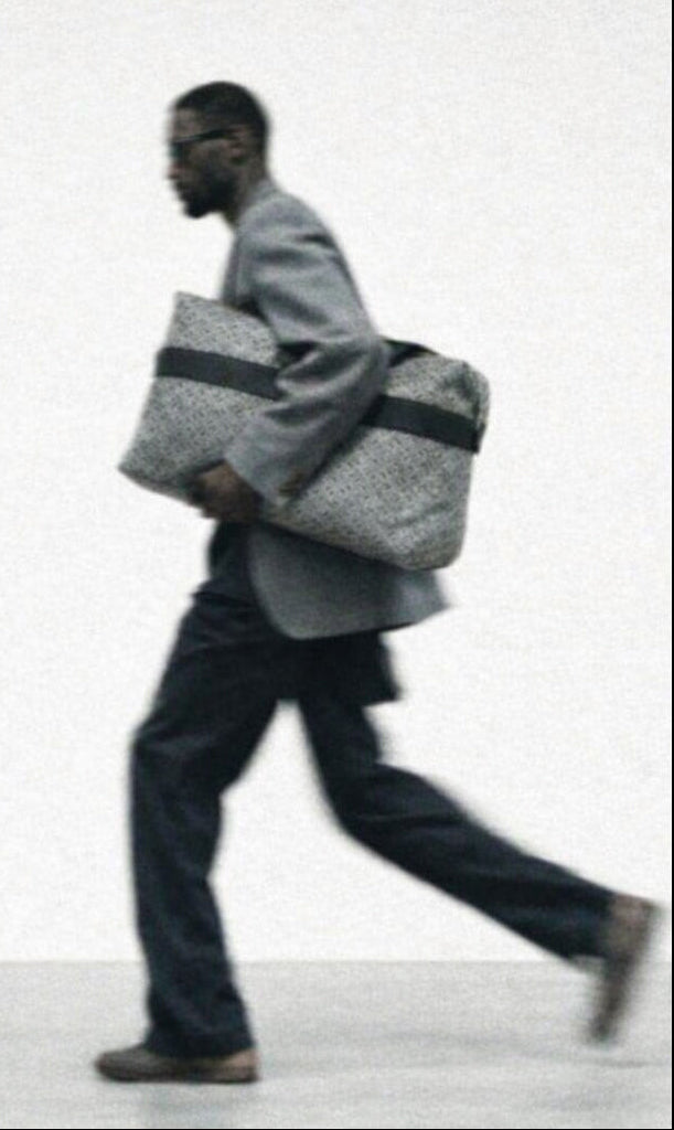 Person walking with a large bag on a plain background